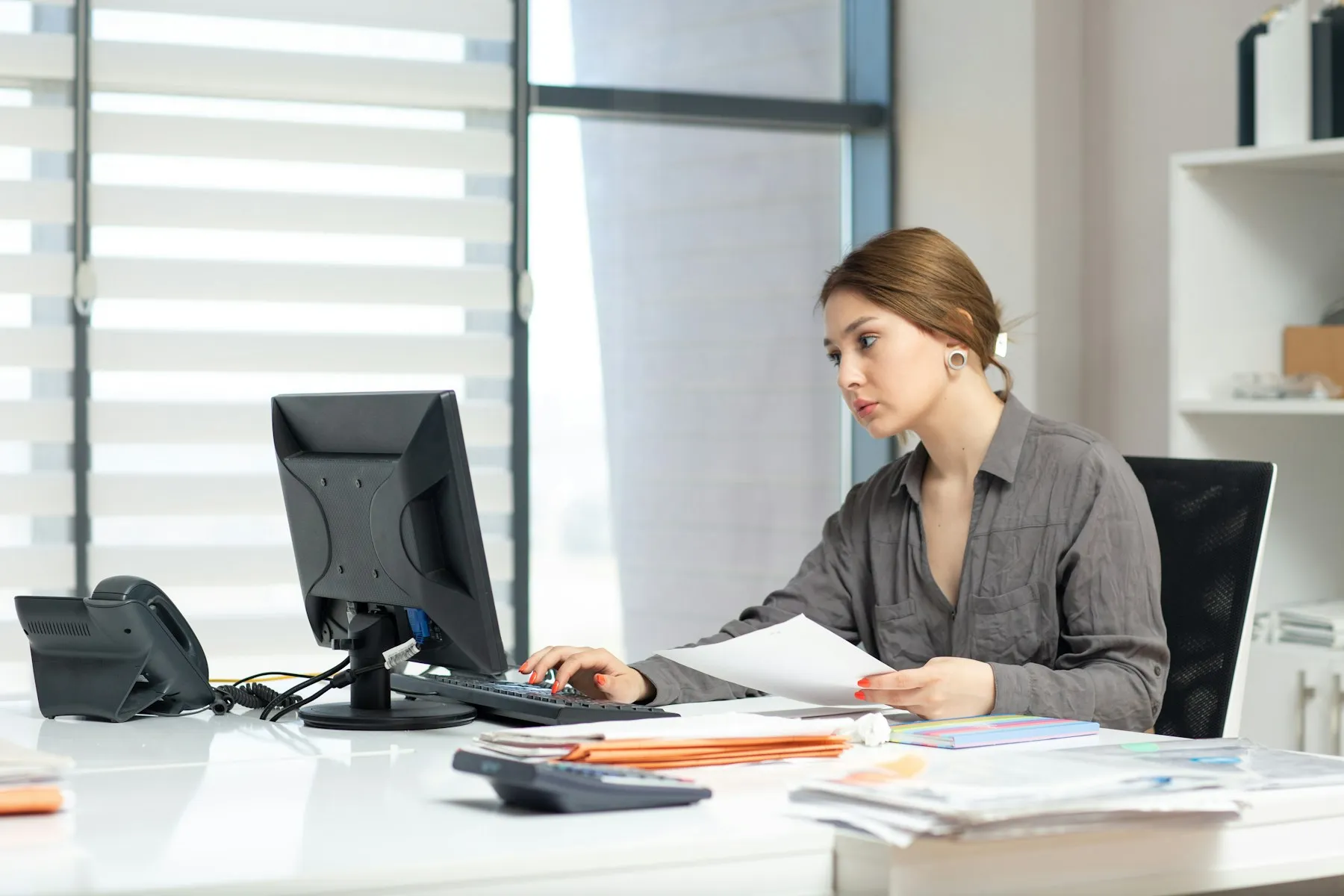 An accountant checking client paperwork at a desk